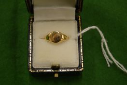 A childs 18ct gold signet ring.