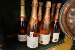 Eight bottles of rose sparkling wine.