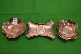A set of three copper coin inset trays.