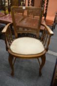 A small beech framed armchair.