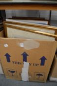 A box of various paintings and prints.