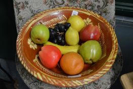 A Slipware bowl containing simulated fruit.