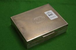 An engine turned silver cigarette box.