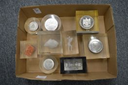 Various commemorative paperweights.