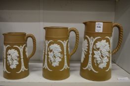 A graduated set of three Jasperware jugs.