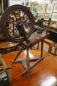 A 19th century spinning wheel with accessories.