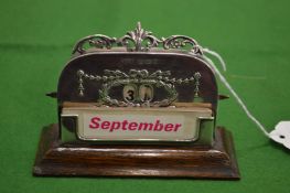 An embossed silver desk calendar.