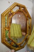A decorative gilt framed mirror.