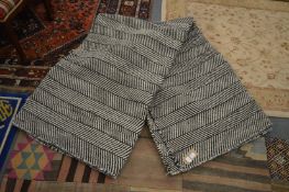 A large black and white herringbone style decorated carpet 280cm x 235cm.