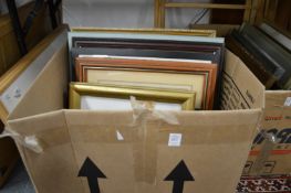 A box of paintings and prints.