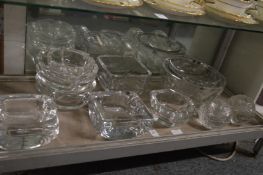 A collection of heavy cut glass bowls and ashtrays by Kosta etc.