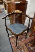 An Edwardian inlaid mahogany corner armchair.