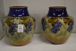 A pair of Royal Doulton vases with grape and vine decoration.