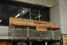 A set of four cantilever dining chairs and a similar bar stool.