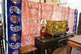 A very good Eastern silk work carpet, coral ground with stylised floral decoration within a