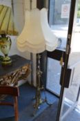 An ornate brass floor standing lamp.