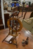 A fruitwood spinning wheel.