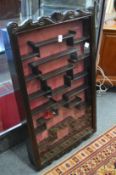 A Chinese hardwood hanging netsuke cabinet.