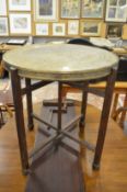 An Eastern embossed brass tray table.