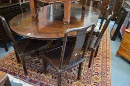 A Chinese hardwood extending table with eight chairs.