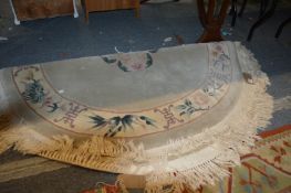 A Chinese circular rug and two other rugs.