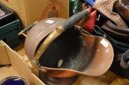 A copper coal scuttle.