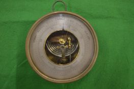 Baker of London, an aneroid barometer, brass cased with silver dial.
