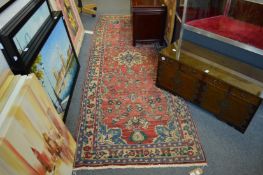 A Persian runner or hall carpet, red ground with stylised decoration 280cm x 100cm.