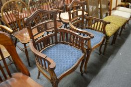 A pair of hardwood open armchairs (repairs).