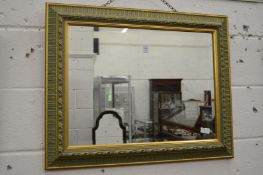Decoratively framed wall mirror.
