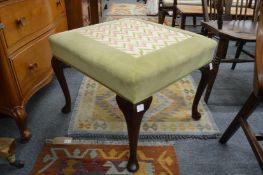 An upholstered stool.