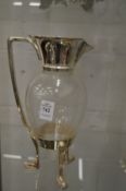 A Christopher Dresser style claret jug with plated mounts.