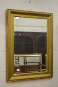 A gilt framed mirror.
