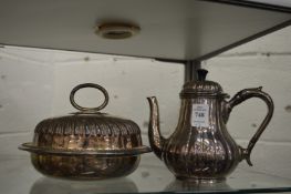 A plated melon shaped coffee pot and a muffin dish and cover.