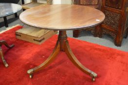 A mahogany circular tripod table.