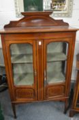 An Edwardian inlaid mahogany two door display cabinet.