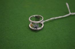 A 18ct white gold diamond and sapphire ring of opened design.