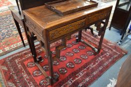 A good Chinese hardwood two drawer side table or desk with carved decoration.