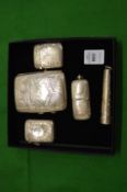 An engraved silver cigarette case, two similar vesta cases and combination vesta/sovereign case