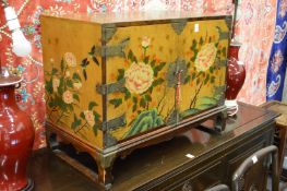 A painted and lacquered Chinese two door cabinet.