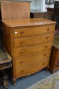 A modern five drawer serpentine fronted bedroom chest.