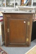 An oak hanging corner cupboard.