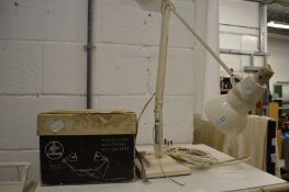 An anglepoise lamp and a heat lamp, boxed.