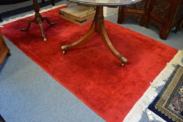 A Chinese red ground carpet 250cm x 150cm.