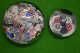 A scramble paperweight and a small millefiori paperweight.