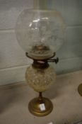 A brass and cut glass oil lamp.