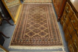 A modern Bokhara style rug, cream ground with stylised decoration 200cm x 130cm.