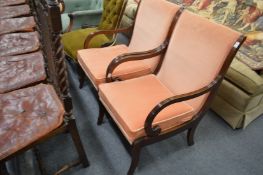 A pair of mahogany open armchairs.