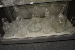 A good collection of cut glass decanters.