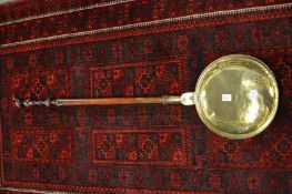 A brass bed warming pan.